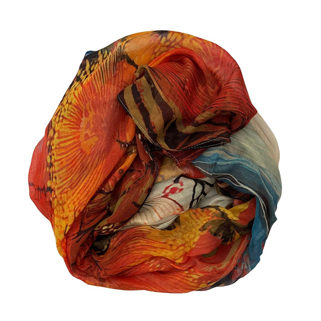 The Artist Label Blue Mountains Golden Hour scarf with floral patterns in gold, orange, grey, brown on a white background