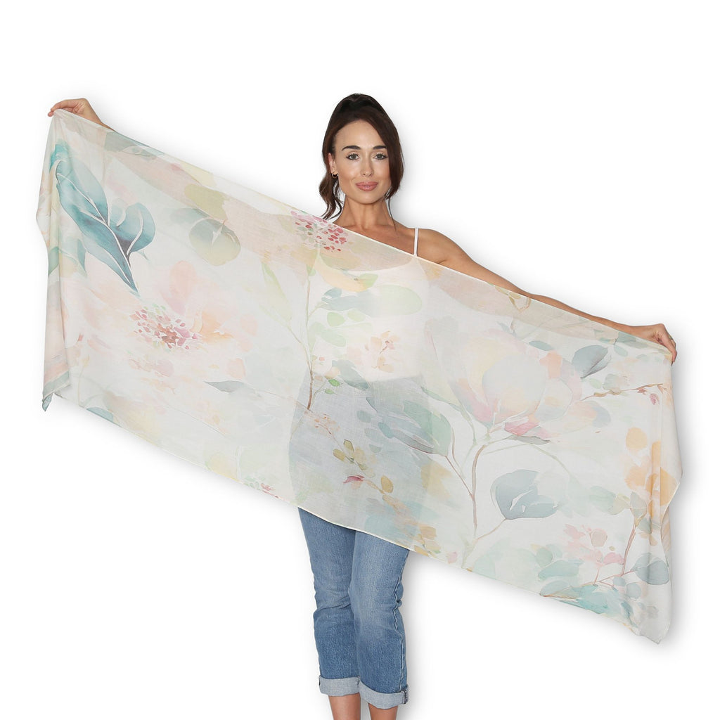 Woman holding The Artist Label Delicate Romance floral scarf in soft pastel shades