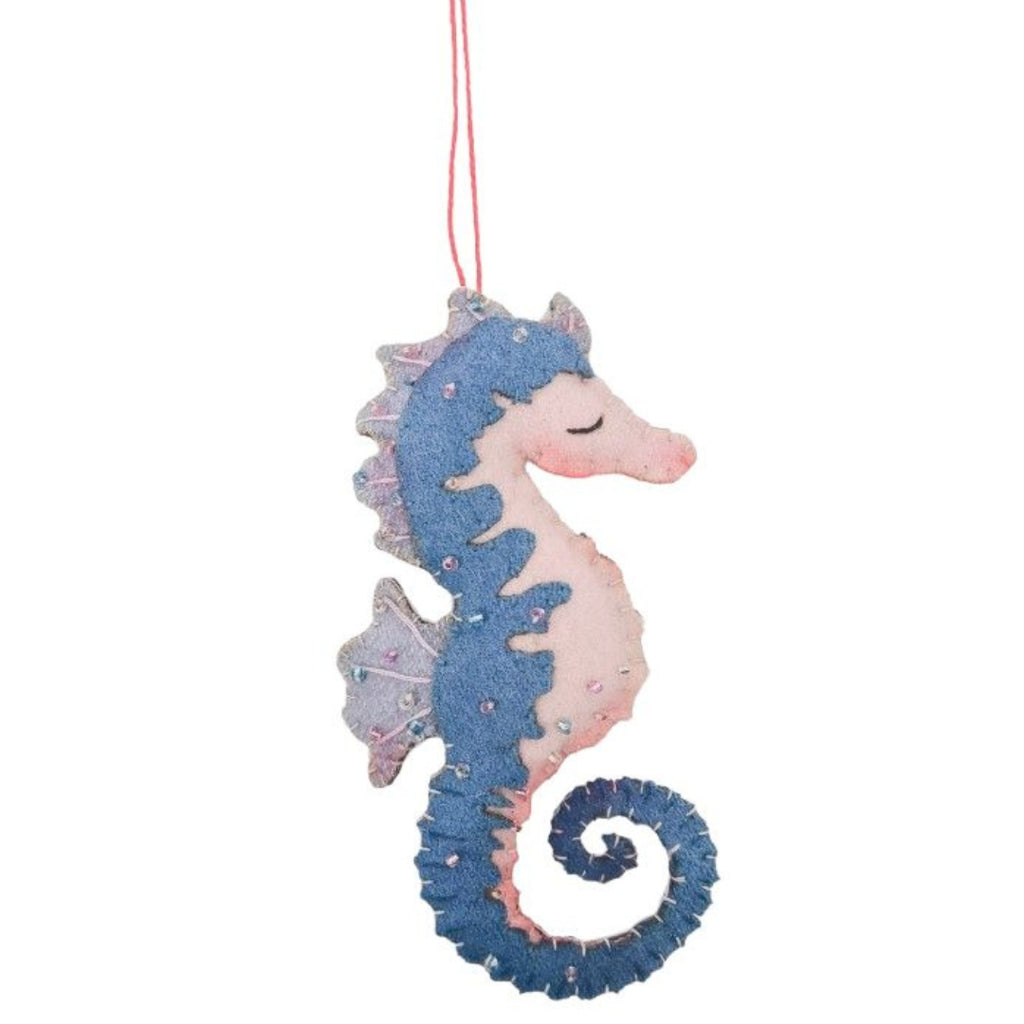 Decorative felt seahorse ornament with pink and blue colors on a white background