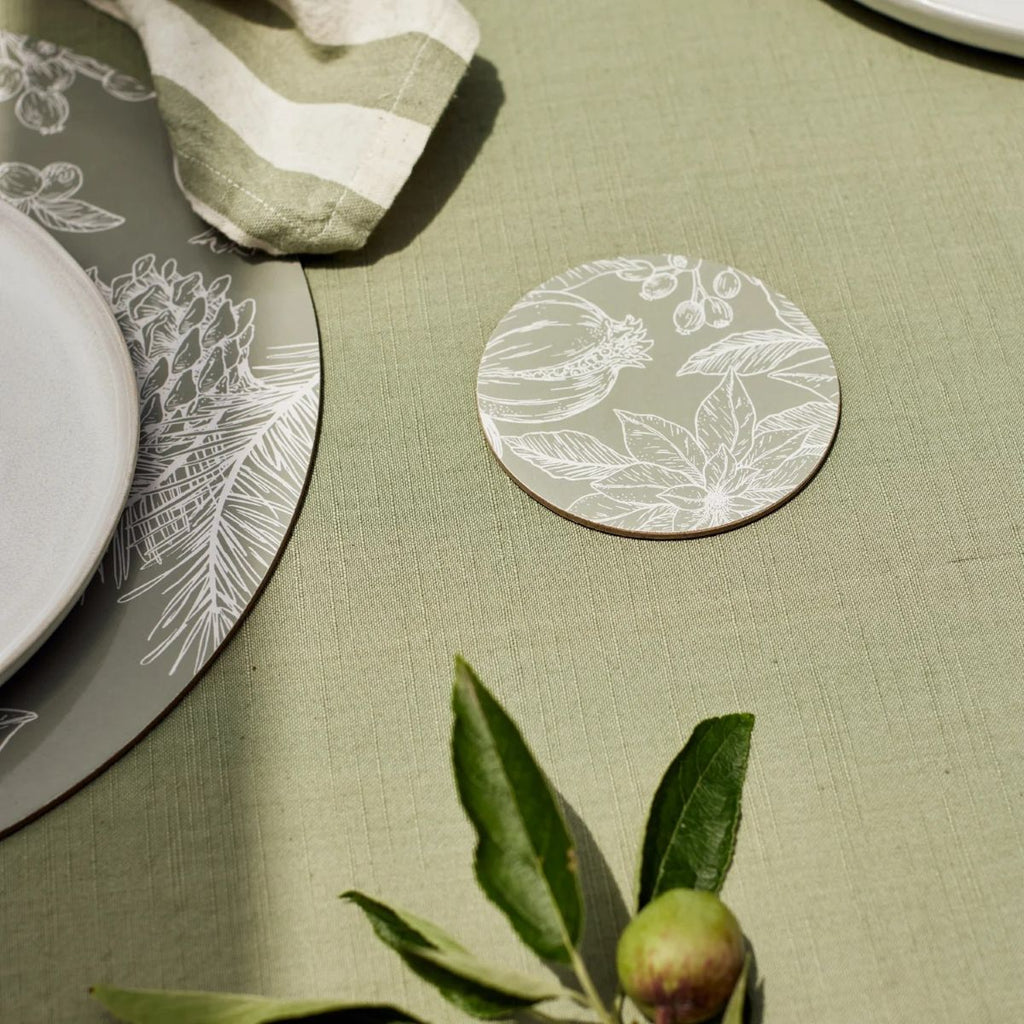 Table setting using a mineral green tablecloth, and poinsettia coaster and placemat