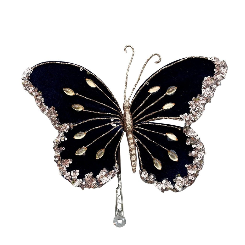 Velvet butterfly in navy blue with gold embellishments on a white background