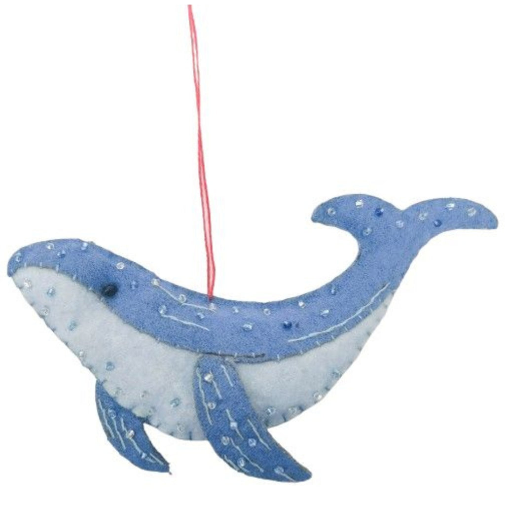 Decorative felt whale ornament with blue and white pattern on a white background