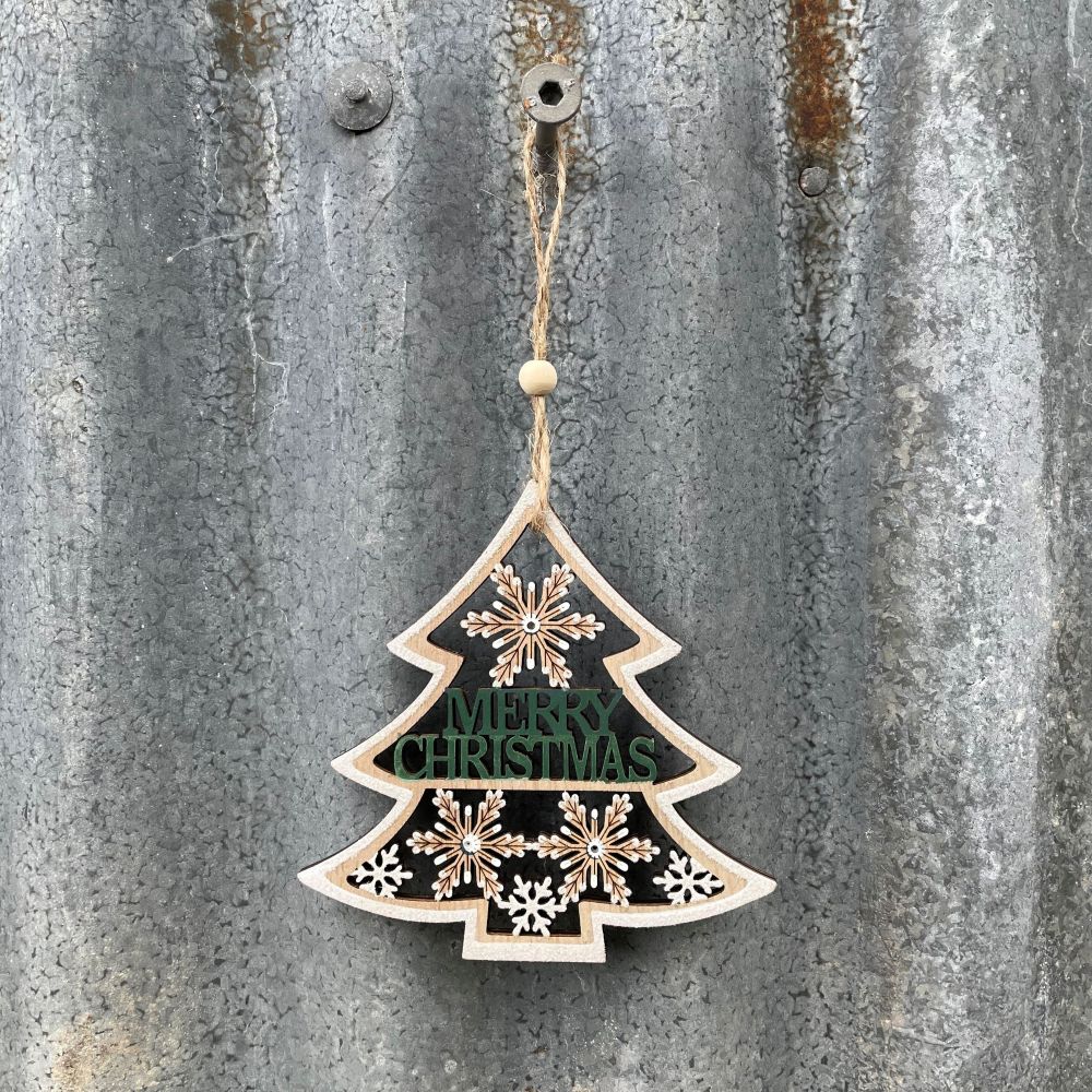 Decorative Christmas tree ornament with 'Merry Christmas' text on a textured metal background