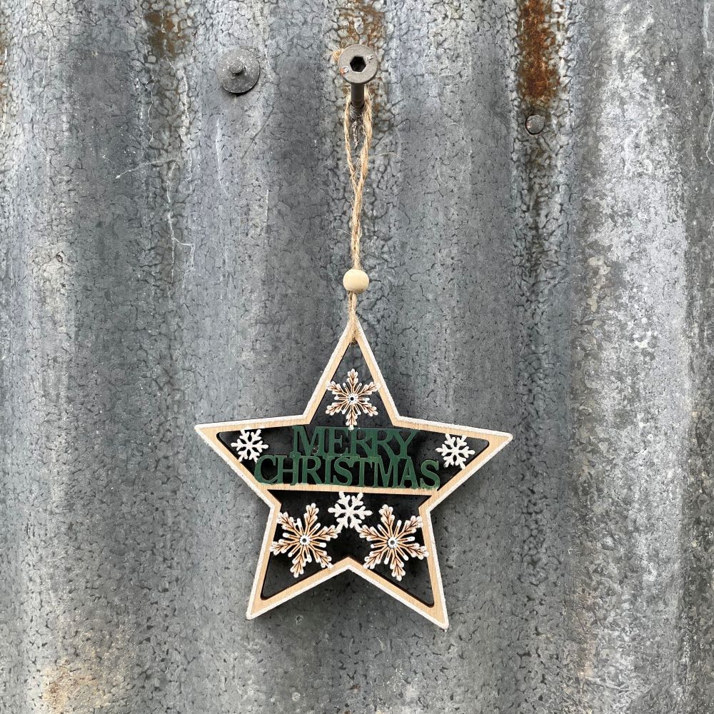 Star-shaped Christmas ornament with 'Merry Christmas' text and snowflakes on a textured metal background.