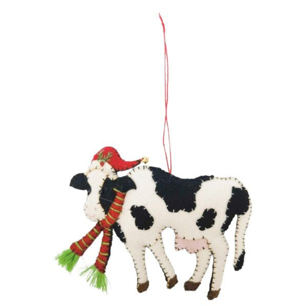 Felt cow ornament with a red hat and scarf on a white background