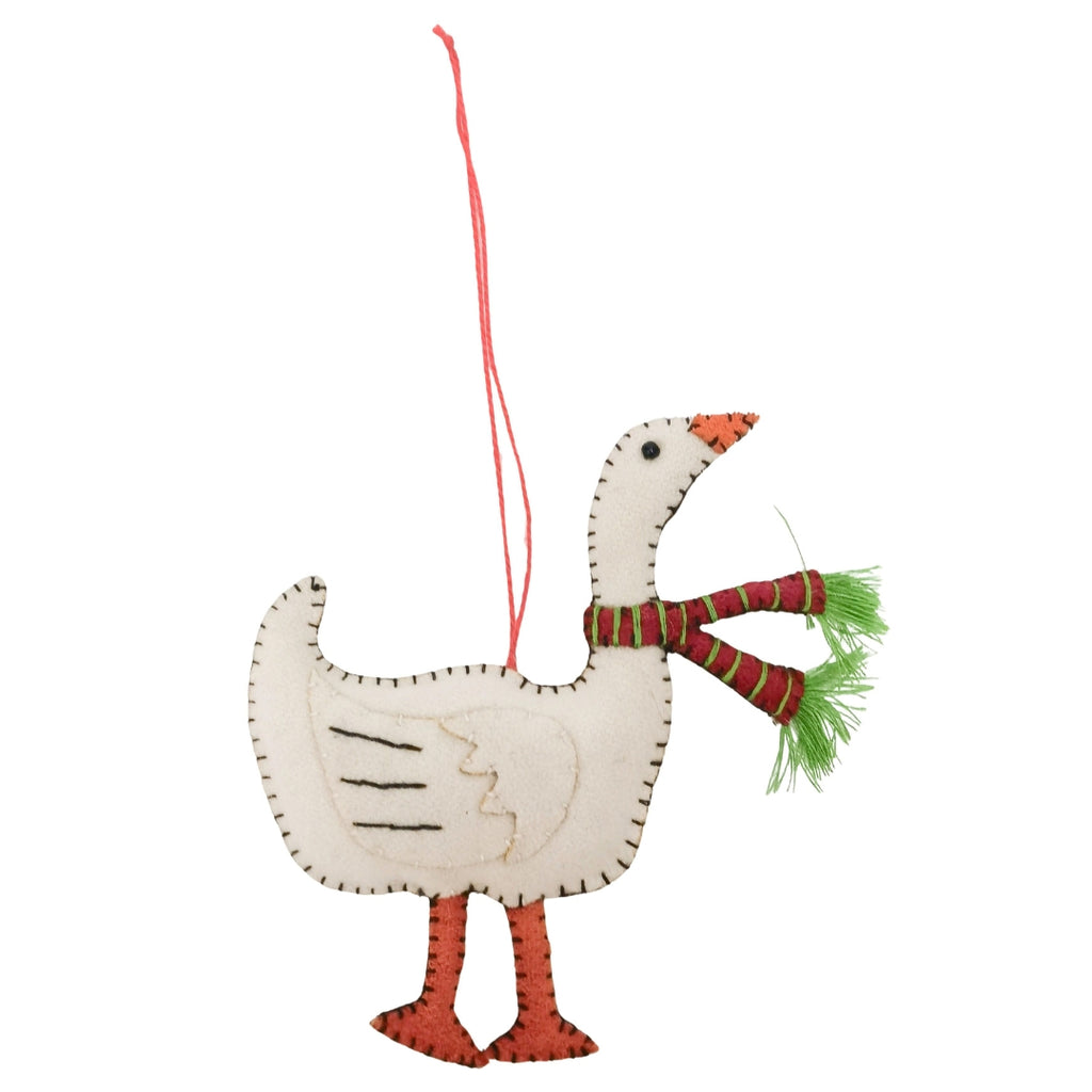 Decorative goose ornament with a red scarf on a white background