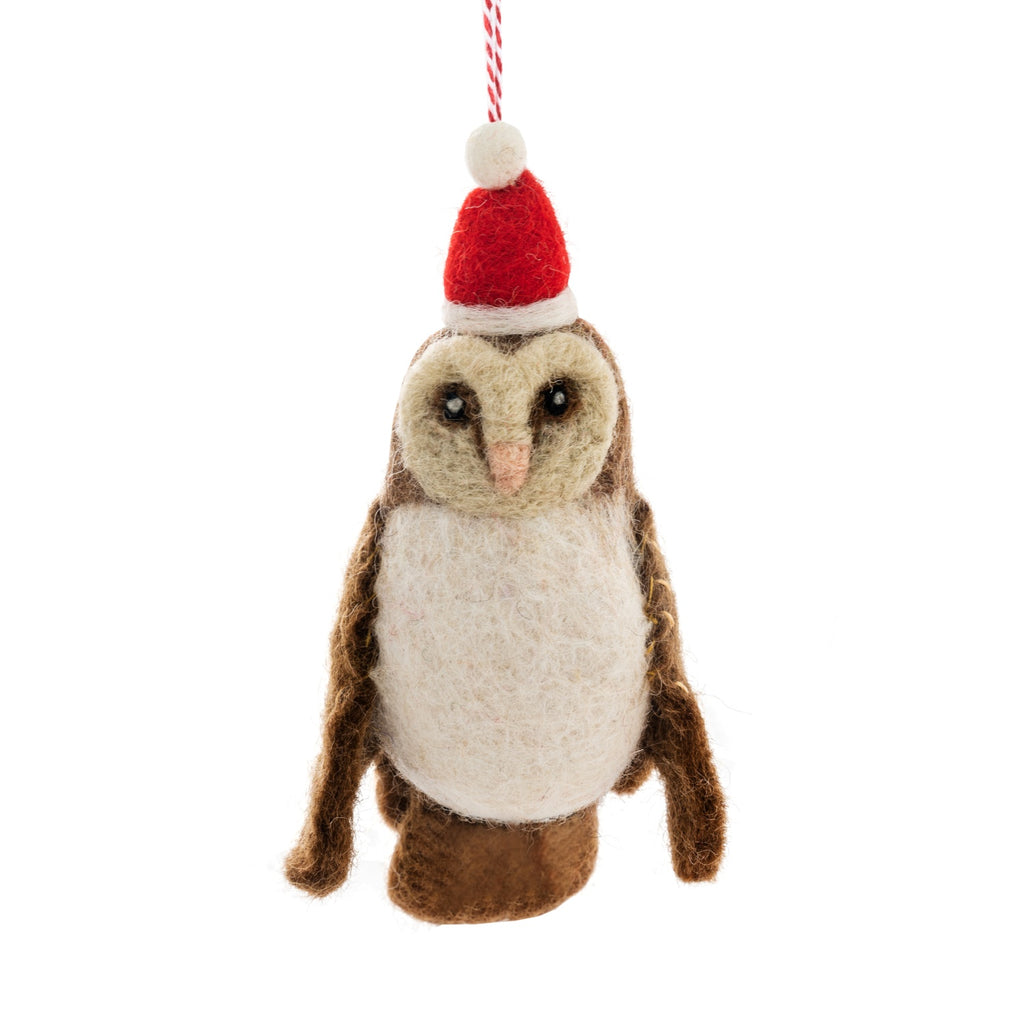 Felted owl ornament wearing a red Santa hat on a white background