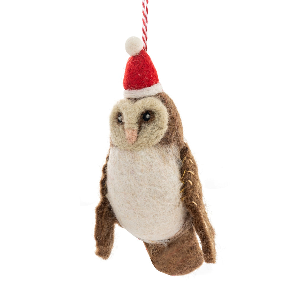 Felt owl ornament wearing a red Santa hat on a white background
