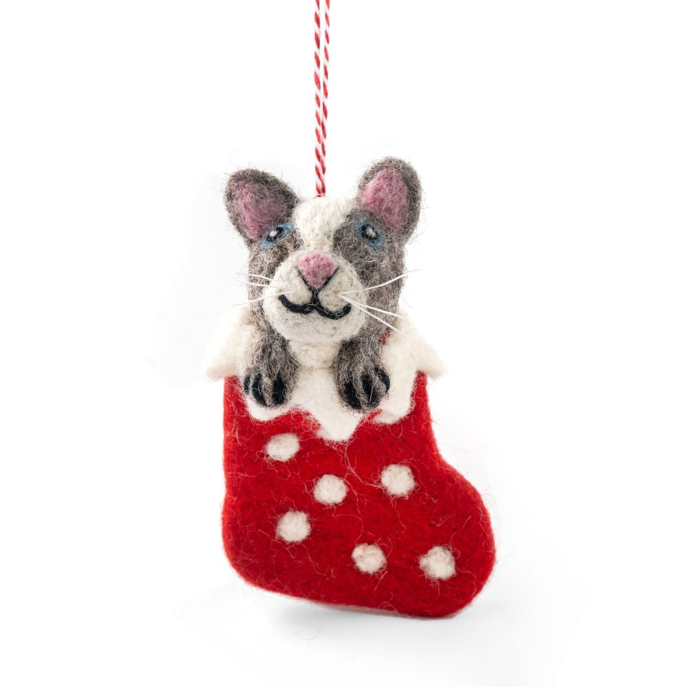 Hanging felted cat ornament in a red stocking on a white background