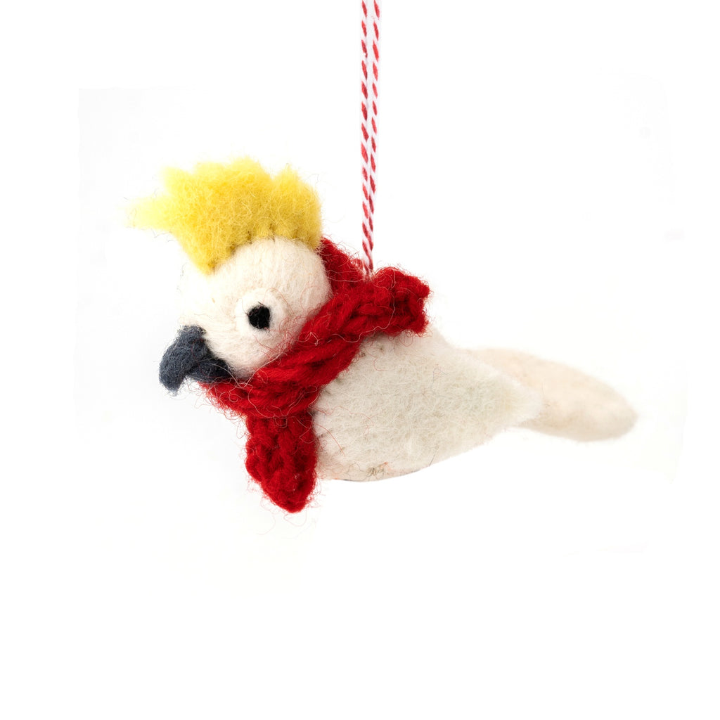 Decorative hanging felt yellow cockatoo ornament with a red scarf on a white background
