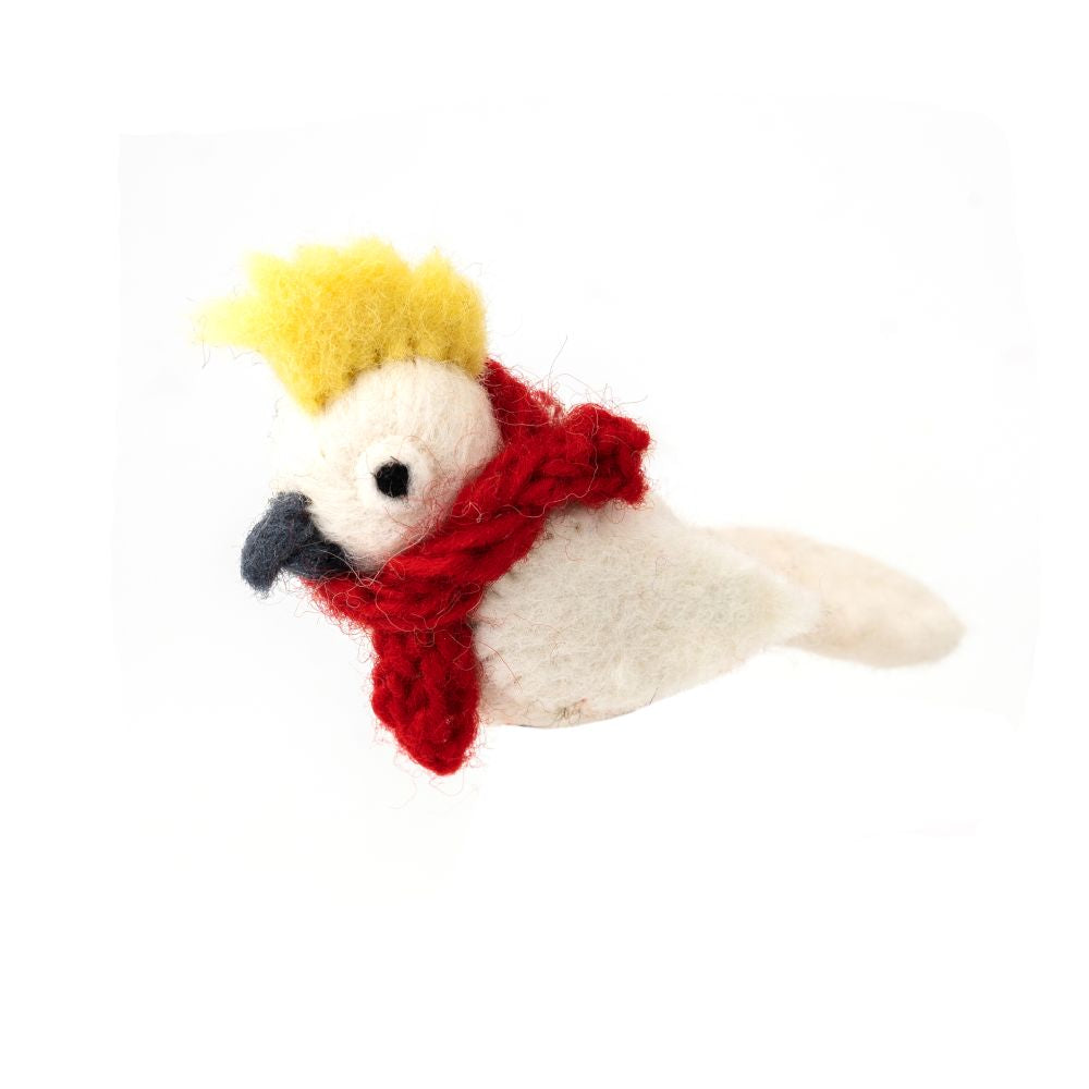 Small yellow cockatoo bird decoration with a red scarf on a white background