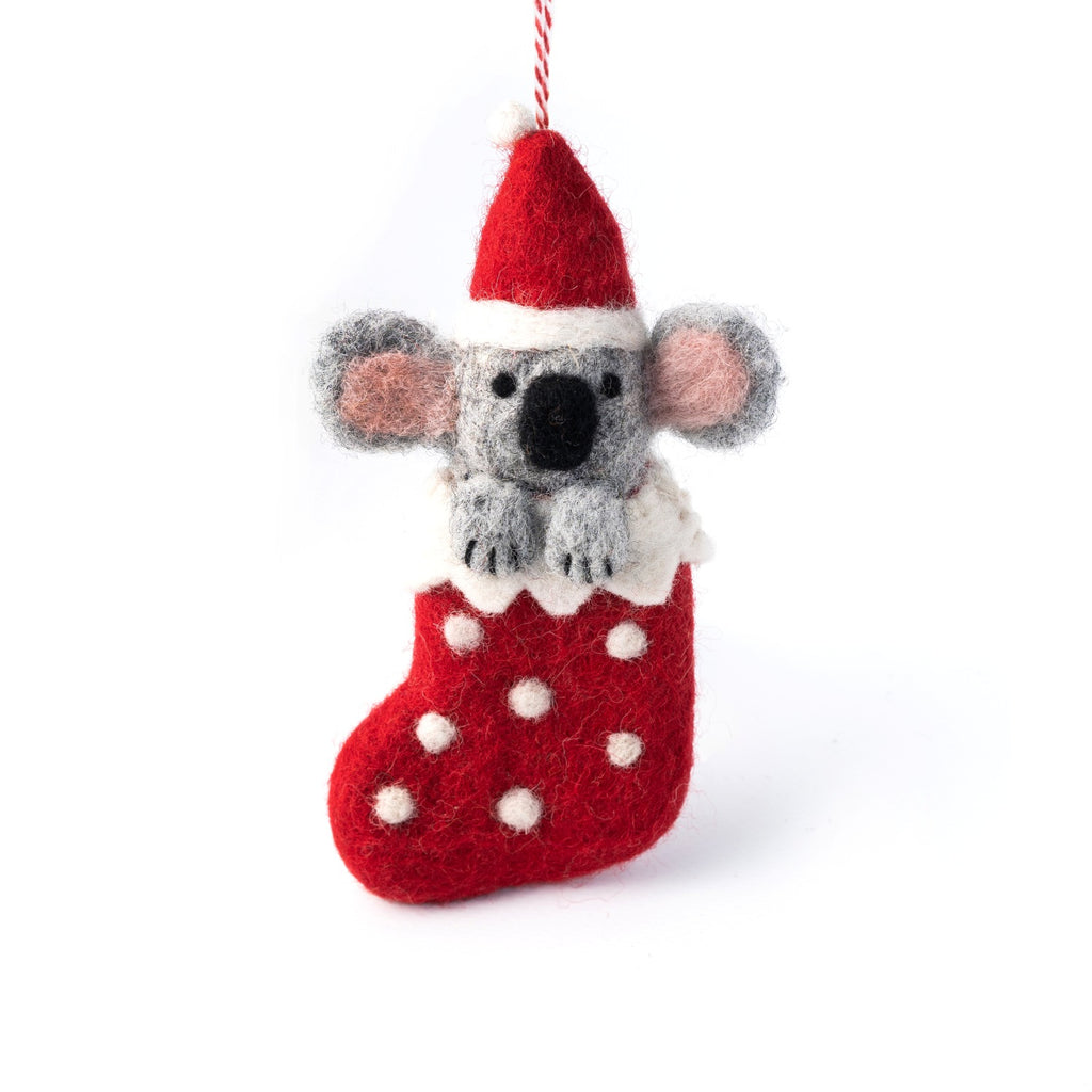 Felted koala ornament in a red stocking with white polka dots on a white background