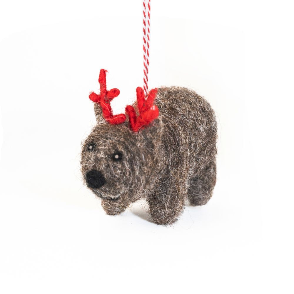 Felted wombat ornament with red antlers on a white background