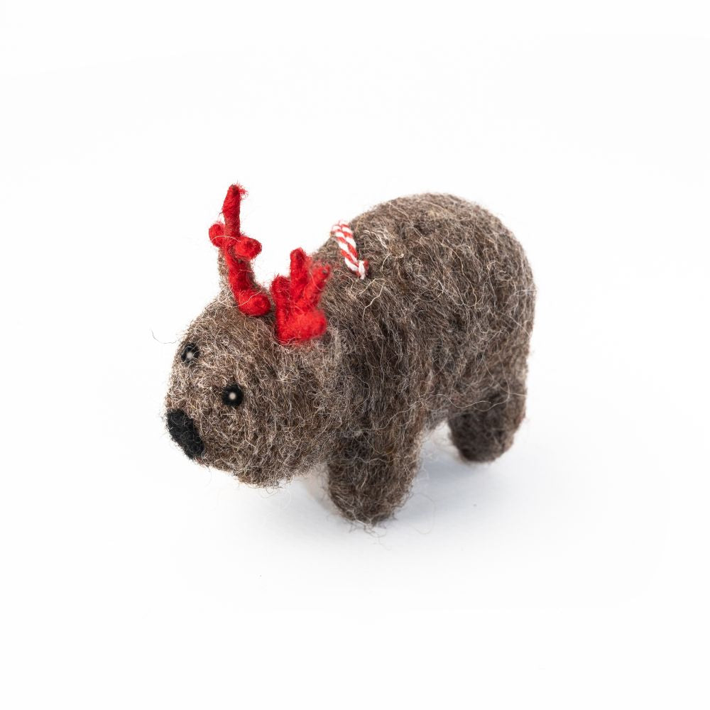Felted wombat ornament with red antlers on a white background