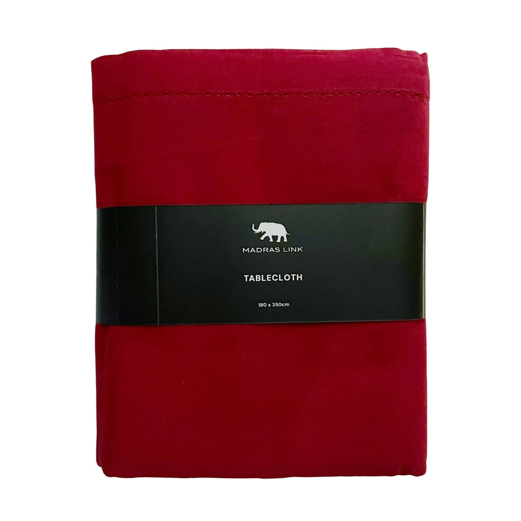 Folded red tablecloth with a black label on a white background