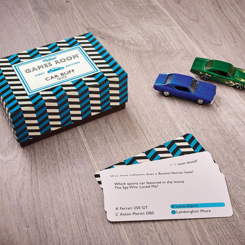 Car Buff trivia Card game set with 'Games Room' box, cards, and toy cars on a wooden surface-  available from Twig and Feather