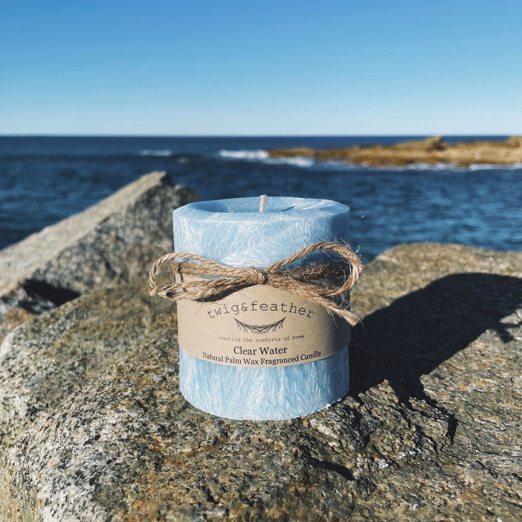 Twig and Feather clear water scented Blue palm wax pillar candle on a rock by the ocean in Bermagui - 38 hour candle