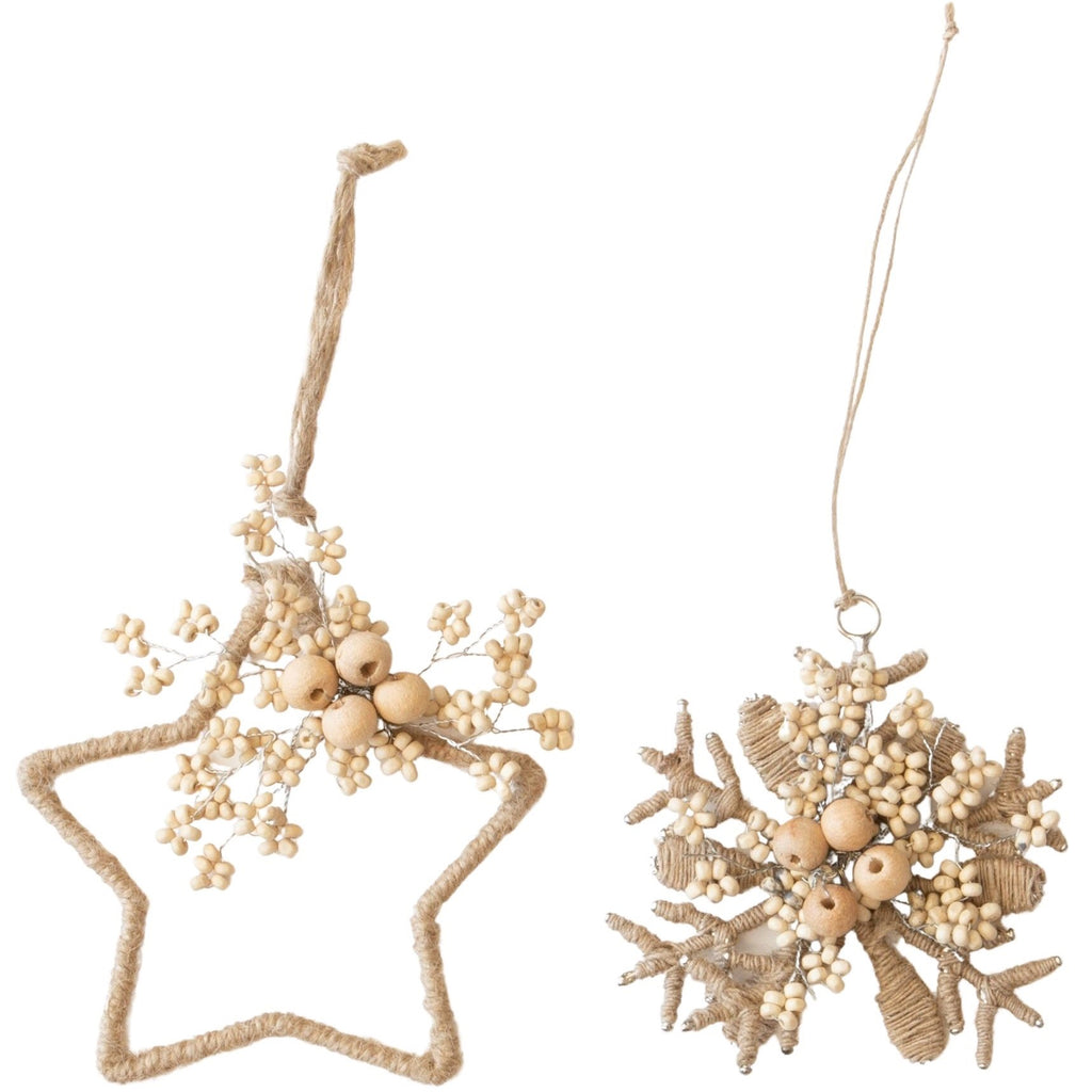 Star and snowflake-shaped natural ornaments with beads and jute on a white background